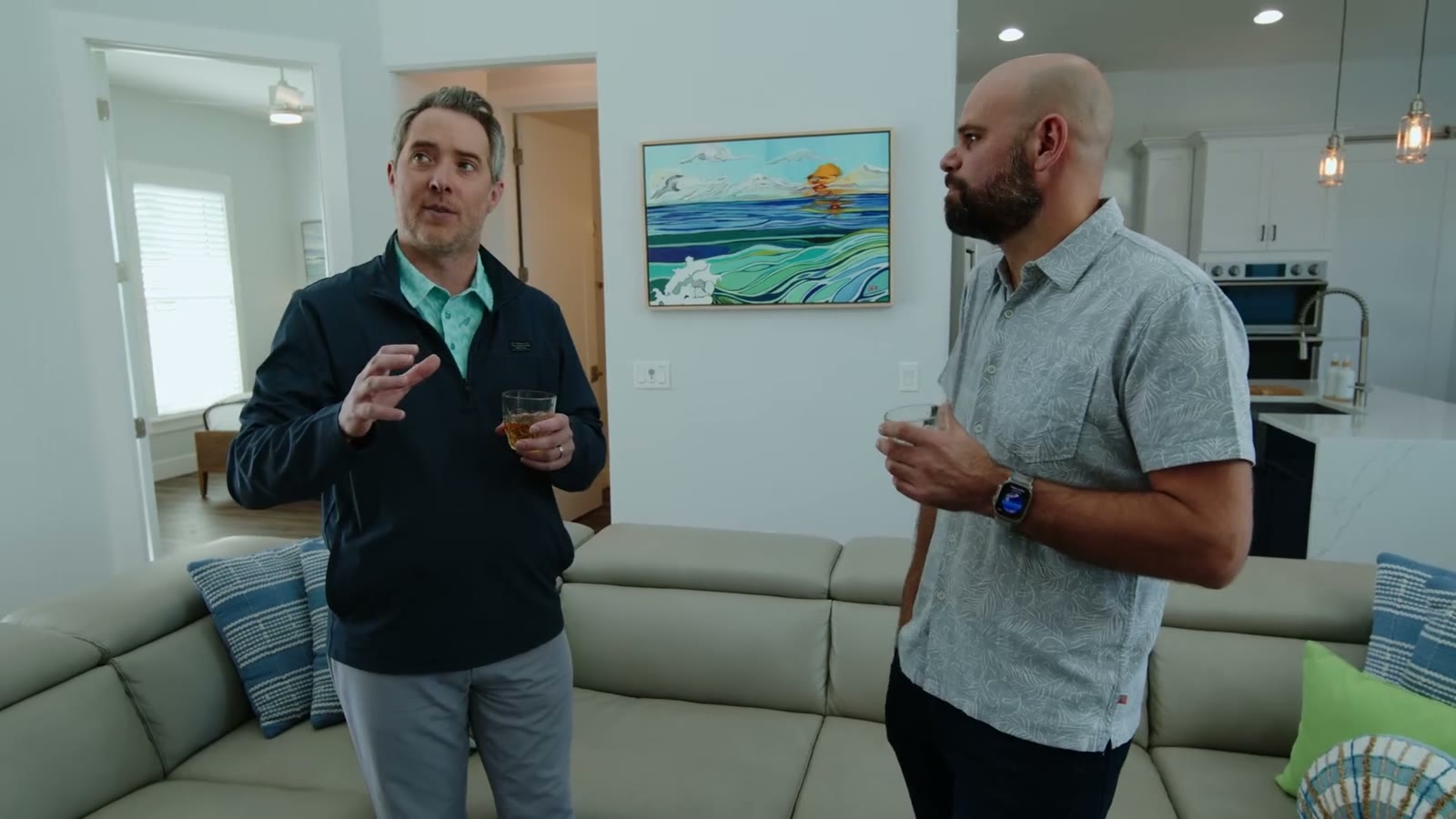 Evan and Nicolas talking through the design, drinks in hand