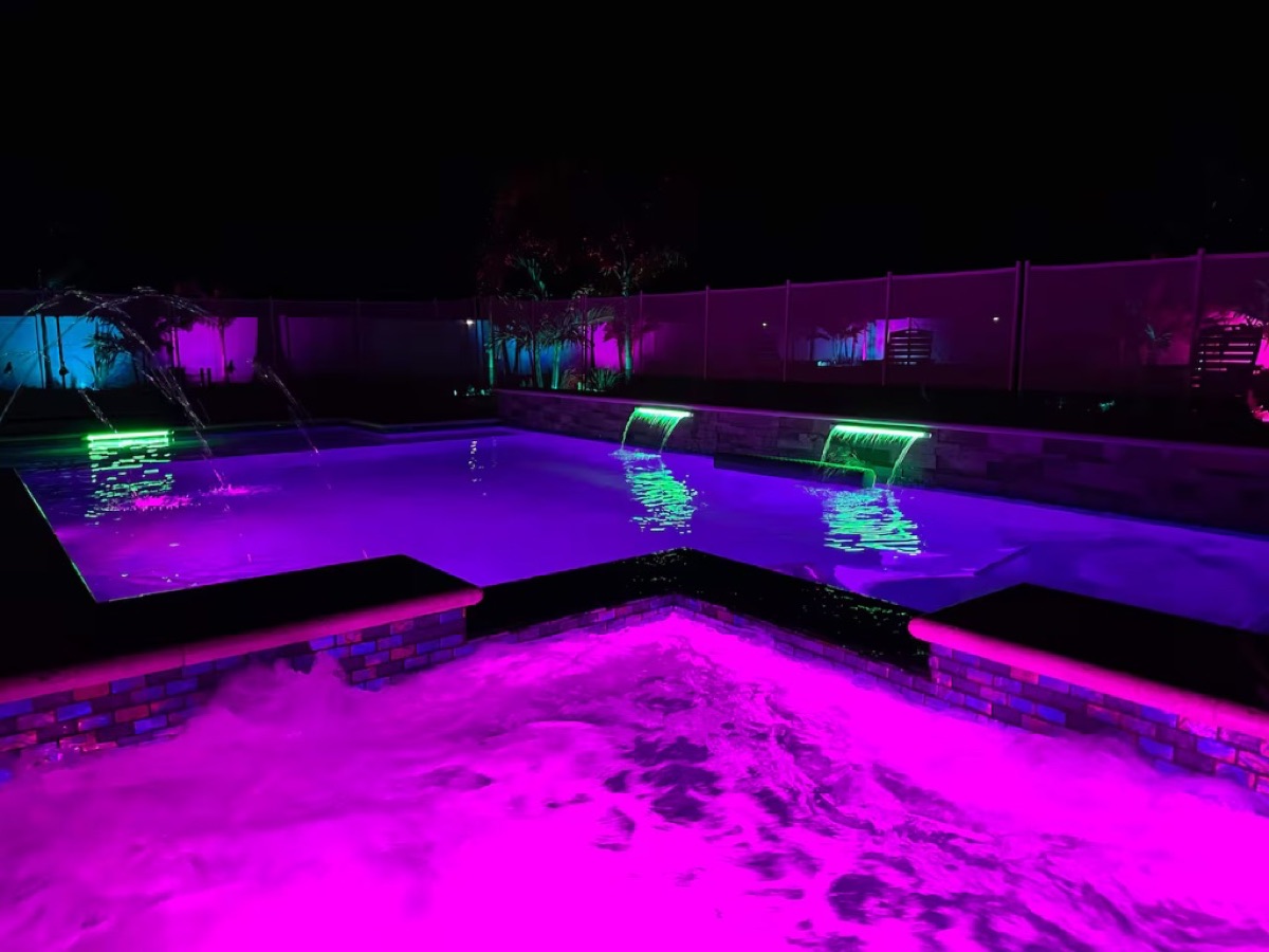 The pool and spa lit at night