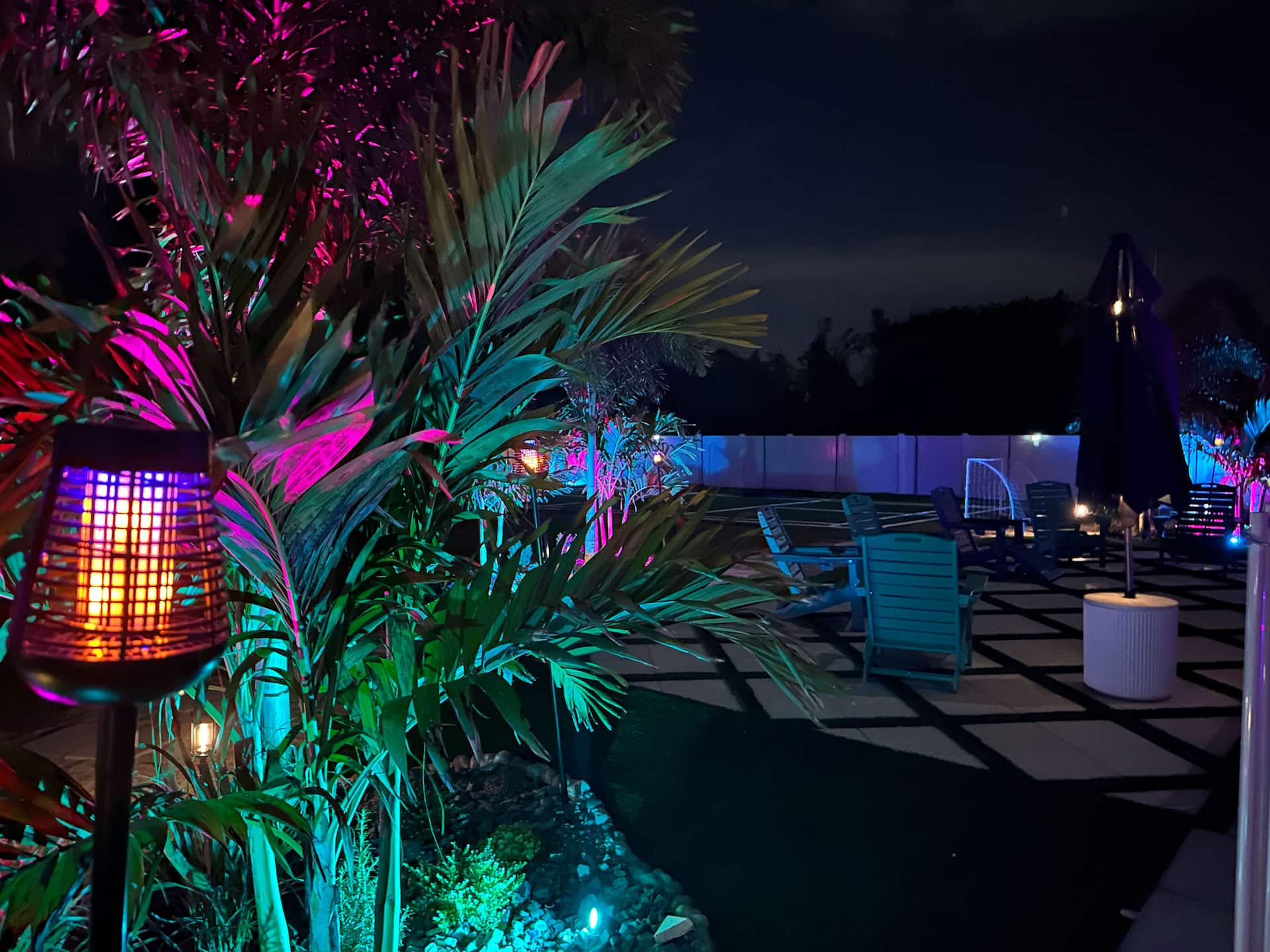 Pool deck illuminated with colorful lighting at night